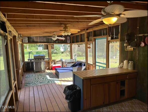 sunroom / solarium with ceiling fan