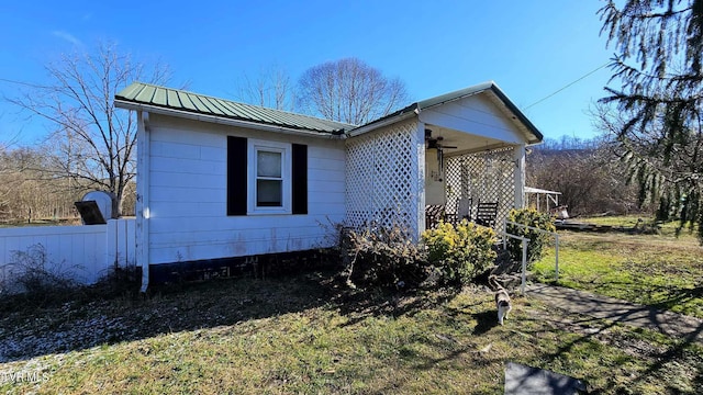 view of side of property with a lawn