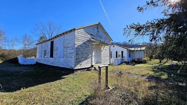 view of side of property with a lawn