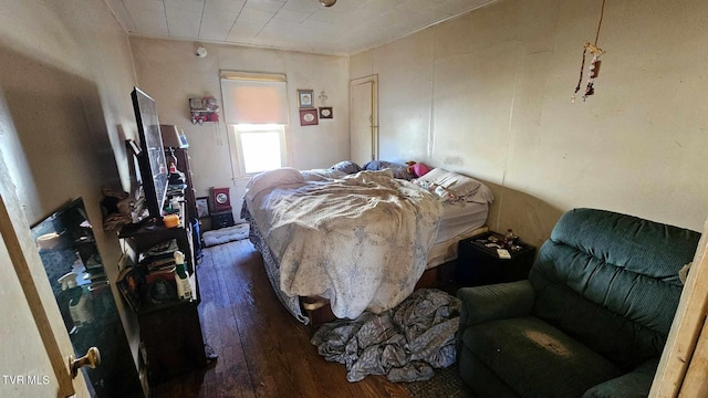 bedroom with dark hardwood / wood-style floors