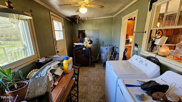 washroom featuring ceiling fan, washing machine and dryer, electric water heater, and crown molding