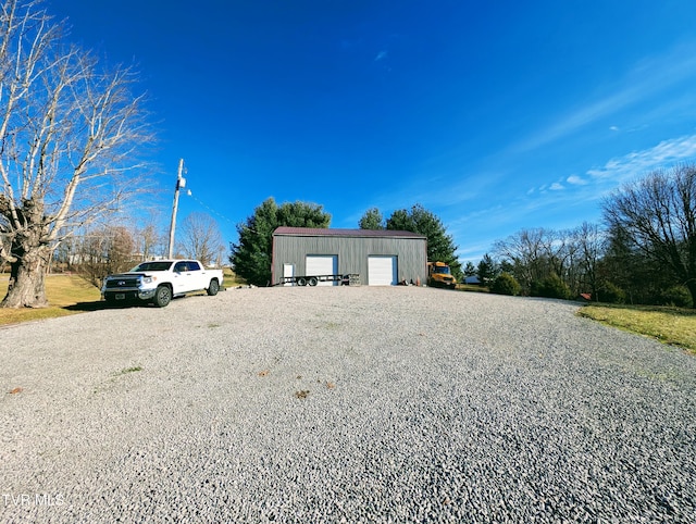 exterior space with a garage and an outbuilding