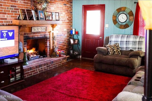 living room with a fireplace and brick wall