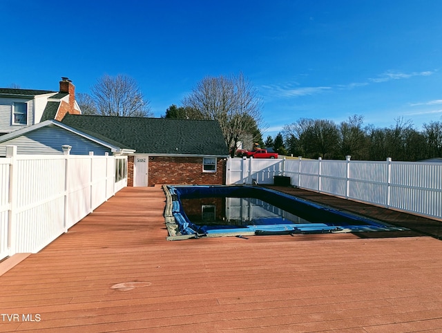 view of pool with a wooden deck