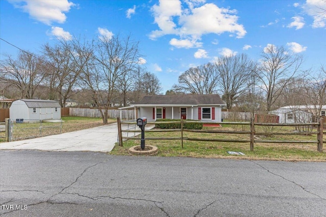 single story home featuring a front yard and a shed