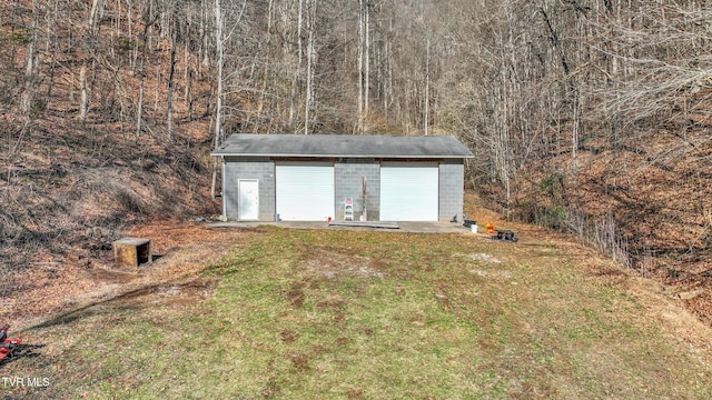 view of outbuilding with a yard and a garage