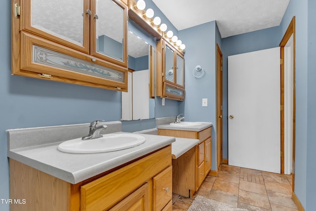 bathroom with vanity and a textured ceiling