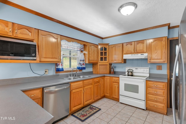 kitchen with light tile patterned flooring, appliances with stainless steel finishes, crown molding, and sink