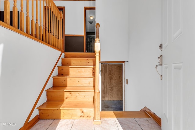 stairway featuring tile patterned floors