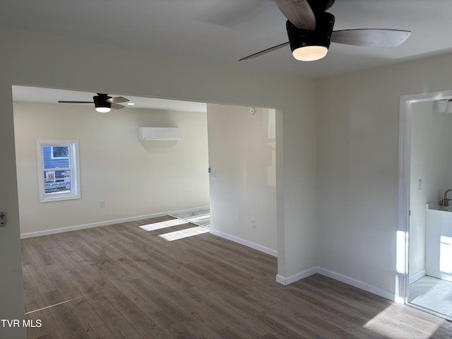 empty room with ceiling fan, wood-type flooring, and a wall mounted AC