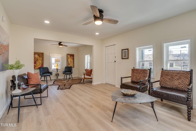 living room with ceiling fan and light wood-type flooring