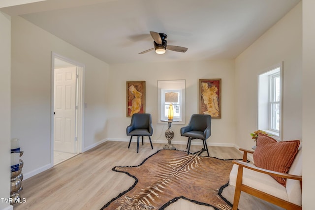 sitting room featuring ceiling fan and light wood-type flooring