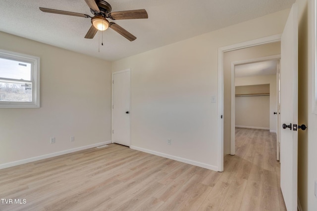 spare room featuring ceiling fan and light hardwood / wood-style flooring