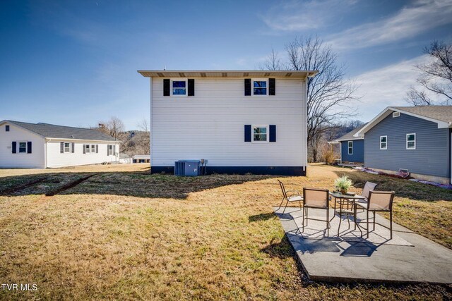 back of house with a patio, an outdoor structure, and a lawn