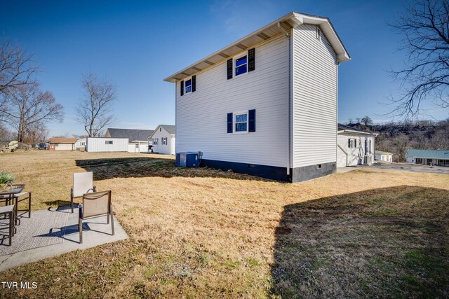 view of property exterior featuring a yard, central AC unit, and a patio area