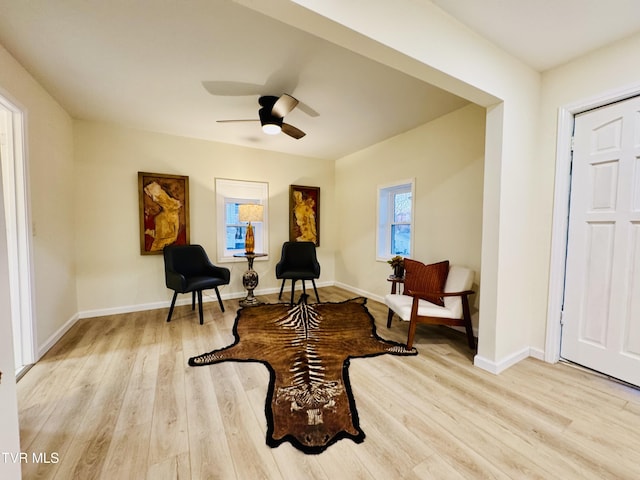 sitting room featuring ceiling fan and light wood-type flooring