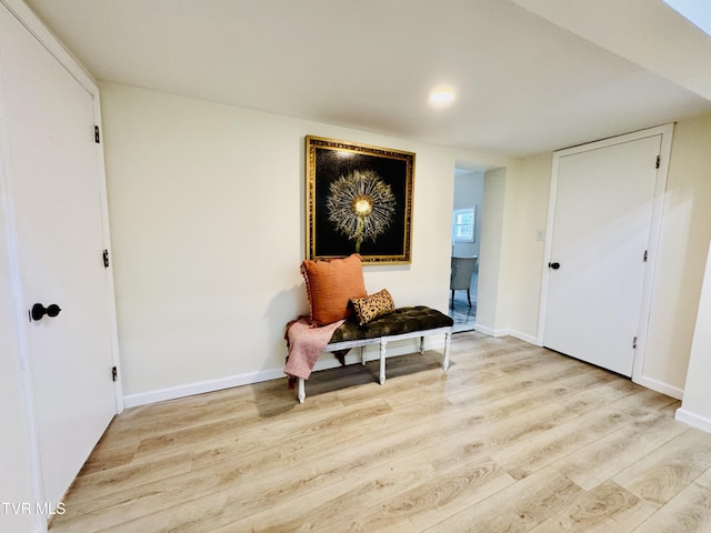 hallway with light hardwood / wood-style flooring