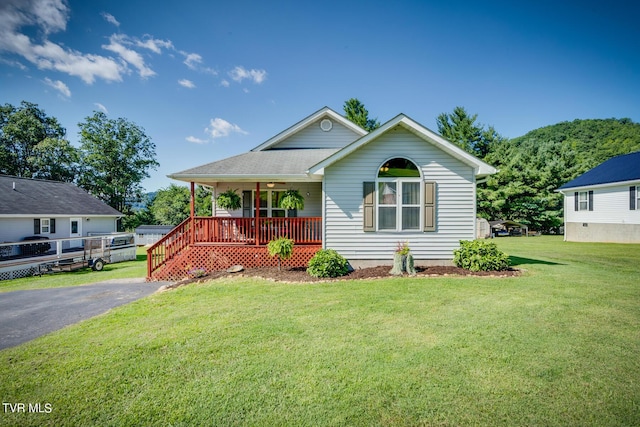 view of front of house featuring covered porch and a front yard