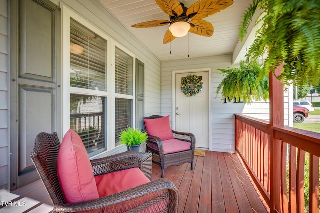 wooden deck with covered porch and ceiling fan