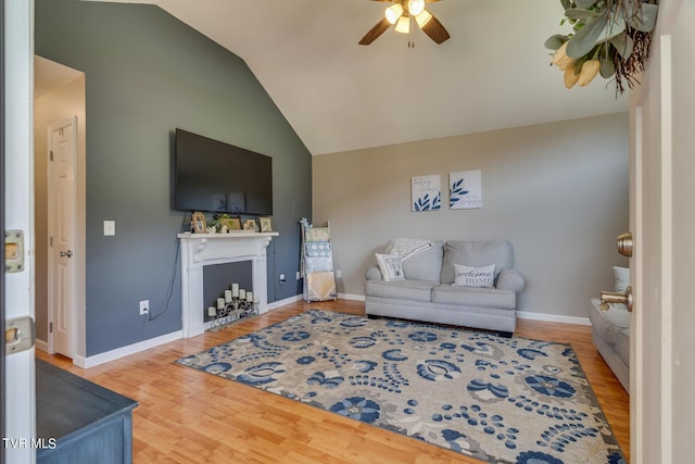 living room with lofted ceiling, wood-type flooring, and ceiling fan