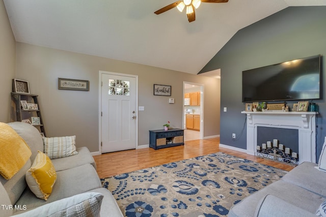 living room featuring lofted ceiling, wood-type flooring, and ceiling fan