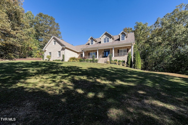 new england style home featuring a front lawn and a porch