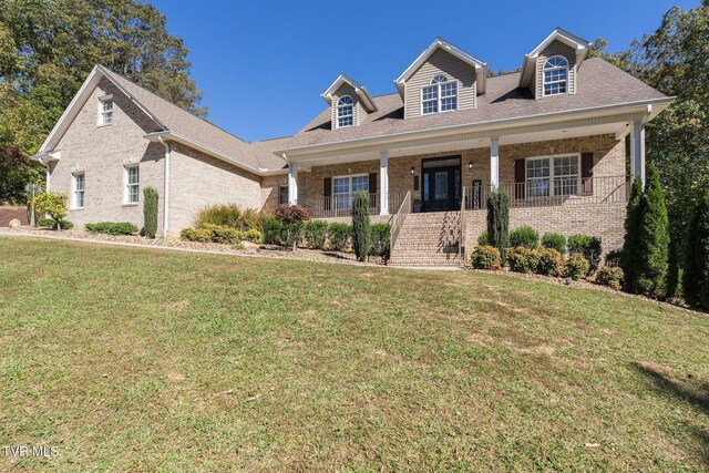 view of front of house with a front yard and a porch