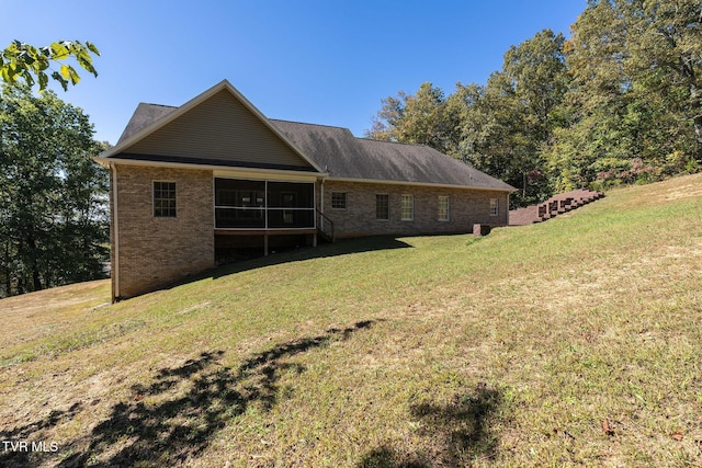 back of house with a yard and a sunroom