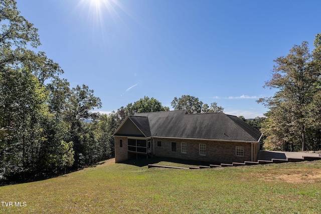 rear view of house featuring a lawn