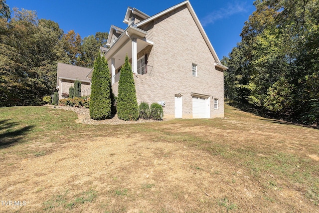 view of side of property with a garage and a yard