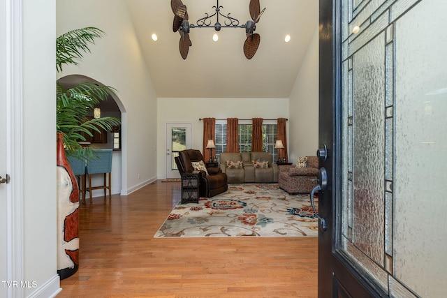 living room featuring high vaulted ceiling and hardwood / wood-style flooring