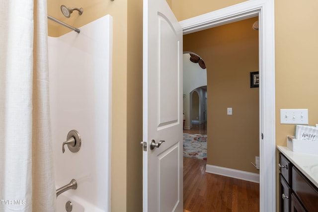 bathroom with vanity, shower / bathtub combination with curtain, and wood-type flooring