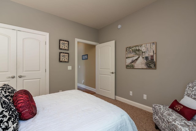 bedroom with dark carpet and a closet