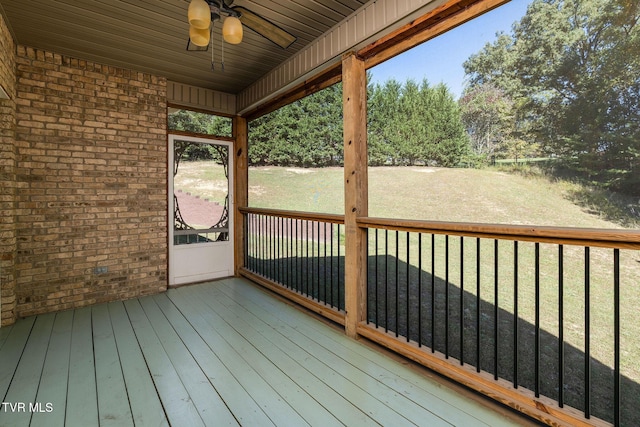 deck featuring a lawn and ceiling fan