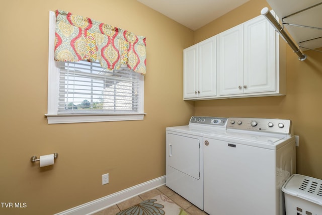 laundry area with cabinets, washing machine and dryer, and light tile patterned flooring