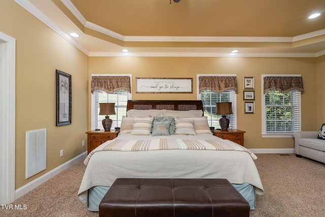 carpeted bedroom featuring a raised ceiling and crown molding