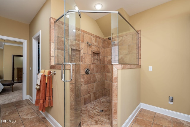 bathroom featuring a shower with door and crown molding