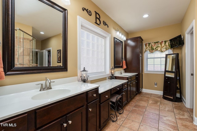 bathroom featuring tile patterned floors, vanity, and walk in shower