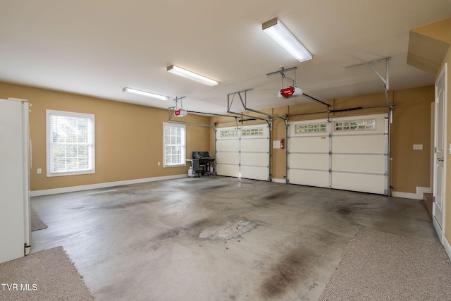 garage with white fridge and a garage door opener