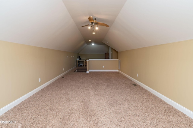 additional living space with ceiling fan, carpet floors, and vaulted ceiling