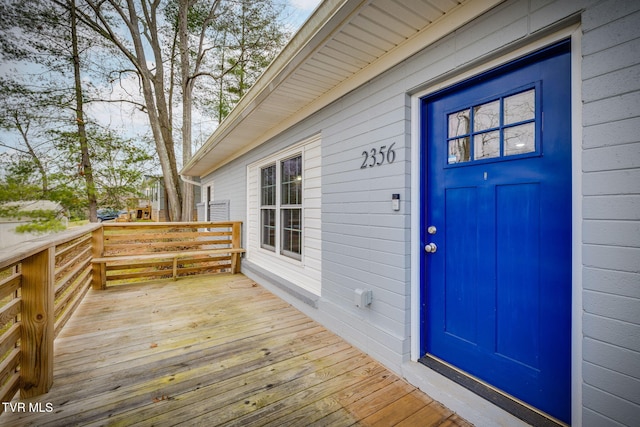 view of exterior entry with a deck