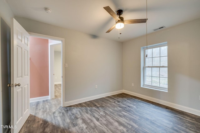 empty room featuring ceiling fan and dark wood-type flooring