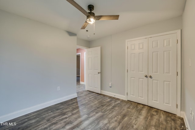 unfurnished bedroom featuring ceiling fan, dark hardwood / wood-style flooring, and a closet