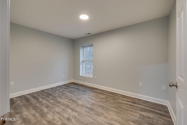 empty room with dark hardwood / wood-style floors