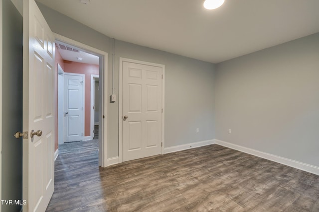 unfurnished room featuring dark hardwood / wood-style floors