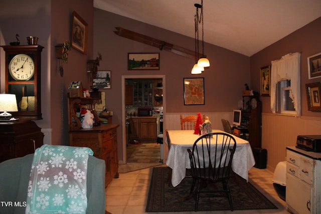 dining area featuring wooden walls and lofted ceiling