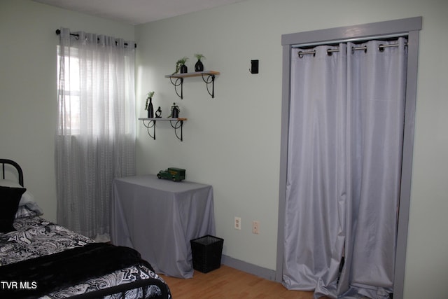 bedroom featuring light hardwood / wood-style floors and a closet