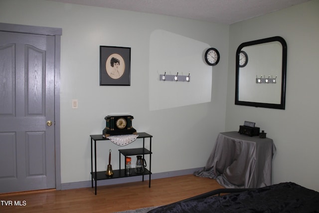 interior space with a textured ceiling and hardwood / wood-style flooring