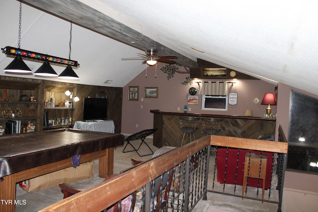 interior space featuring wood walls, vaulted ceiling with beams, ceiling fan, a textured ceiling, and pool table