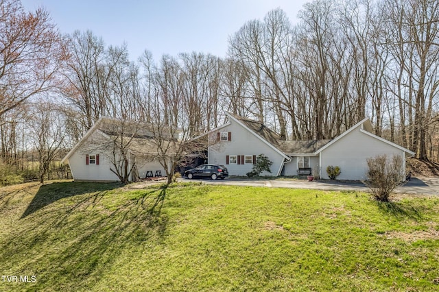 exterior space featuring driveway and a front yard